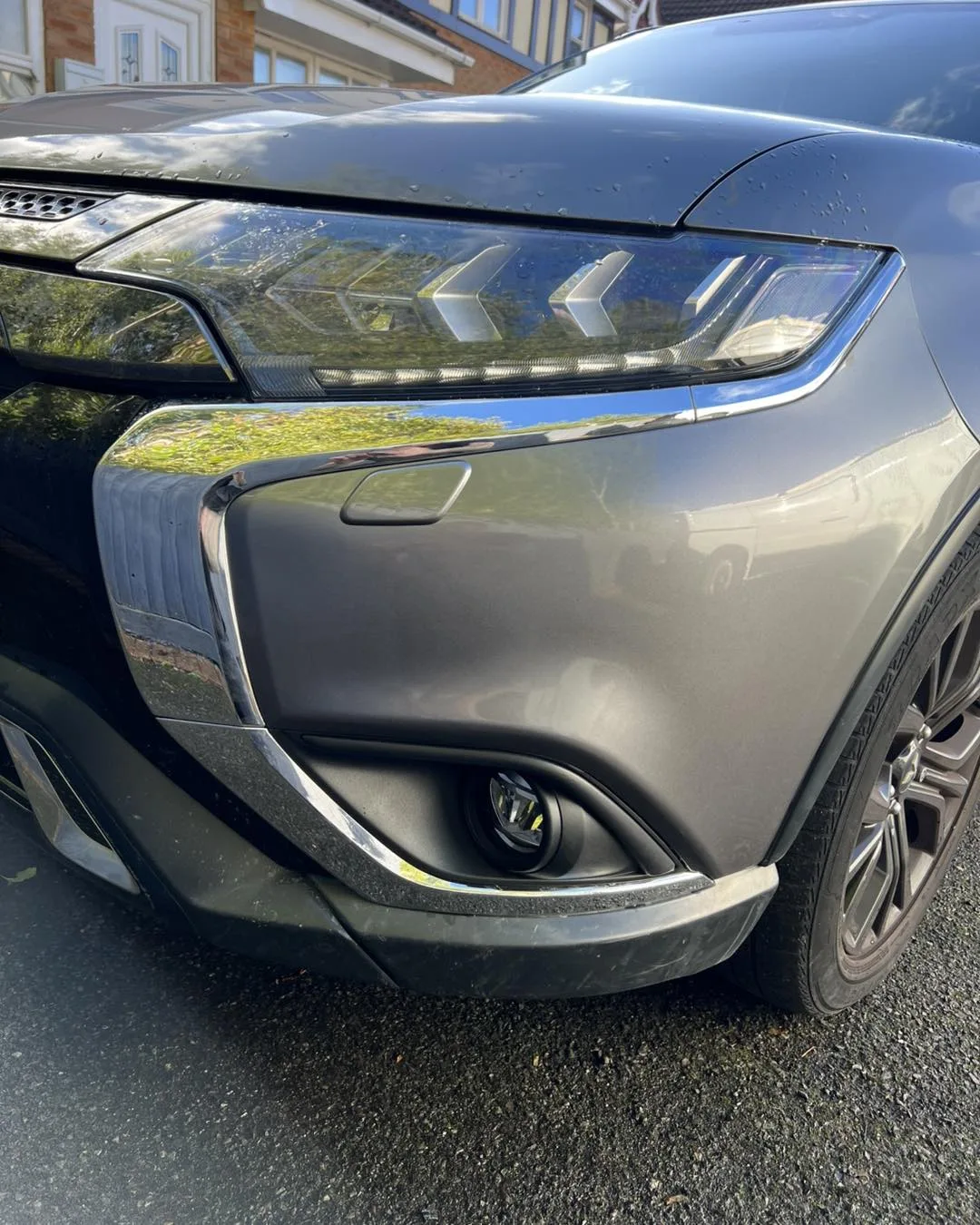 Finished grey car front bumper in sunlight